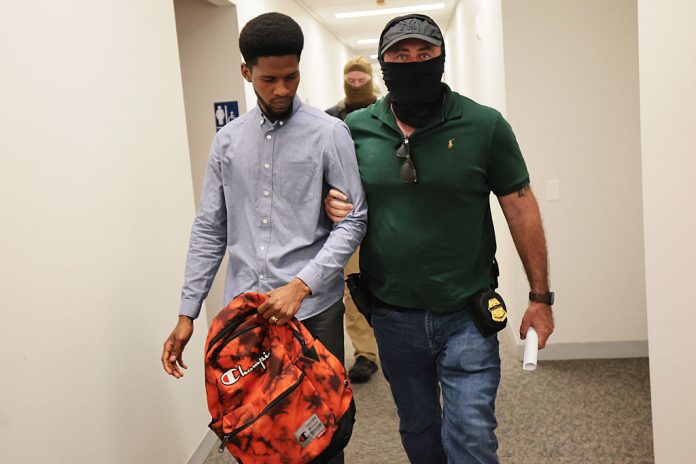 Federal agents detain an individual as he exits immigration court in New York City in July. Immigrants released at the border are being targeted for arrest when they show up for court hearings. (Michael M. Santiago/Getty Images)