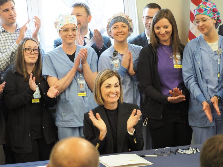Gov. Kim Reynolds signed two health care bills into law at the Guthrie County Hospital in Guthrie Center May 28, 2025, including her proposal to increase rural health care accessibility. (Photo by Robin Opsahl/Iowa Capital Dispatch)