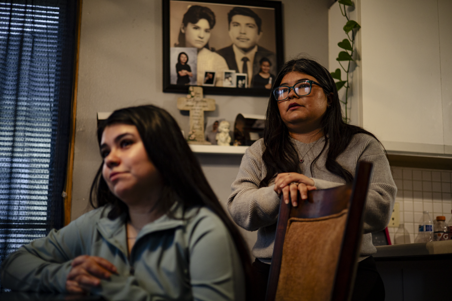 Juan Lopez's daughters sit in their Des Moines dining room.