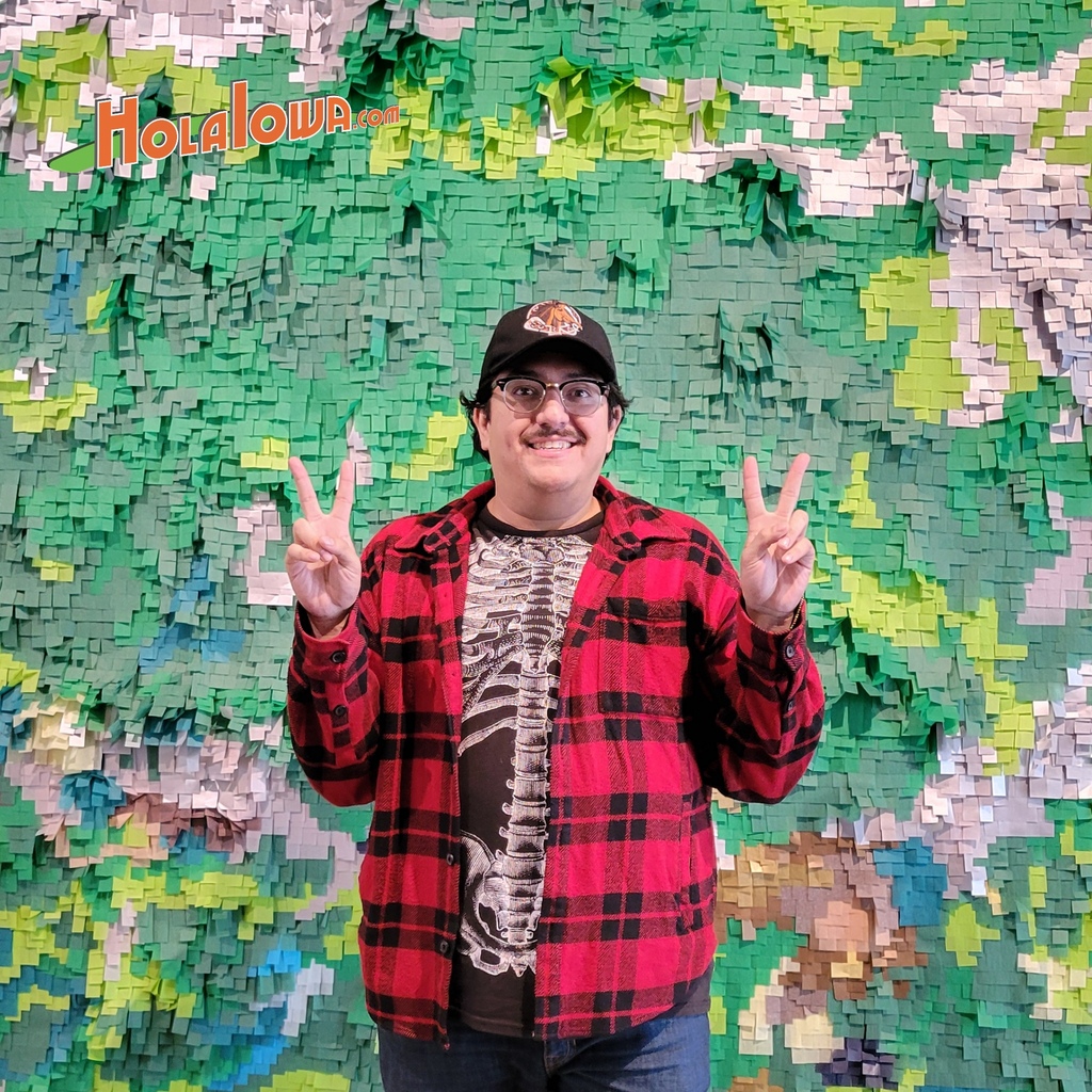 Artist Justin Favela stands in front of his artwork at the Des Moines Art Center.