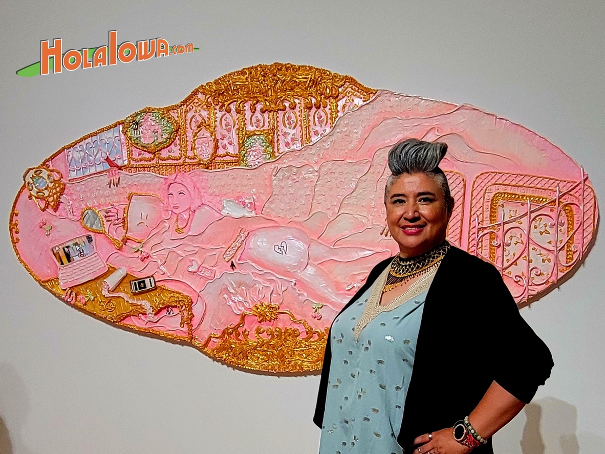 Erika Macias stands in front of a pink artwork by Quad Cities native Yvette Mayorga at the Des Moines Art Center.