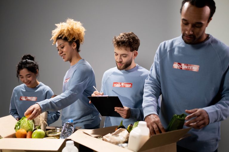 Volunteers sorting and packing donated food into boxes during a community service activity.